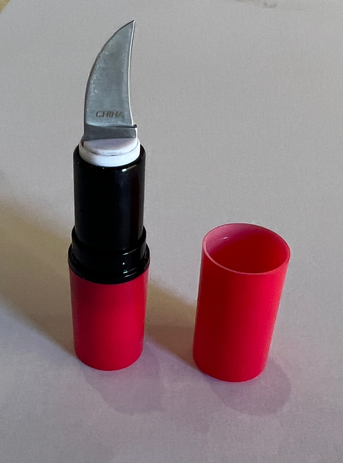 Lipstick case pocket knife prop