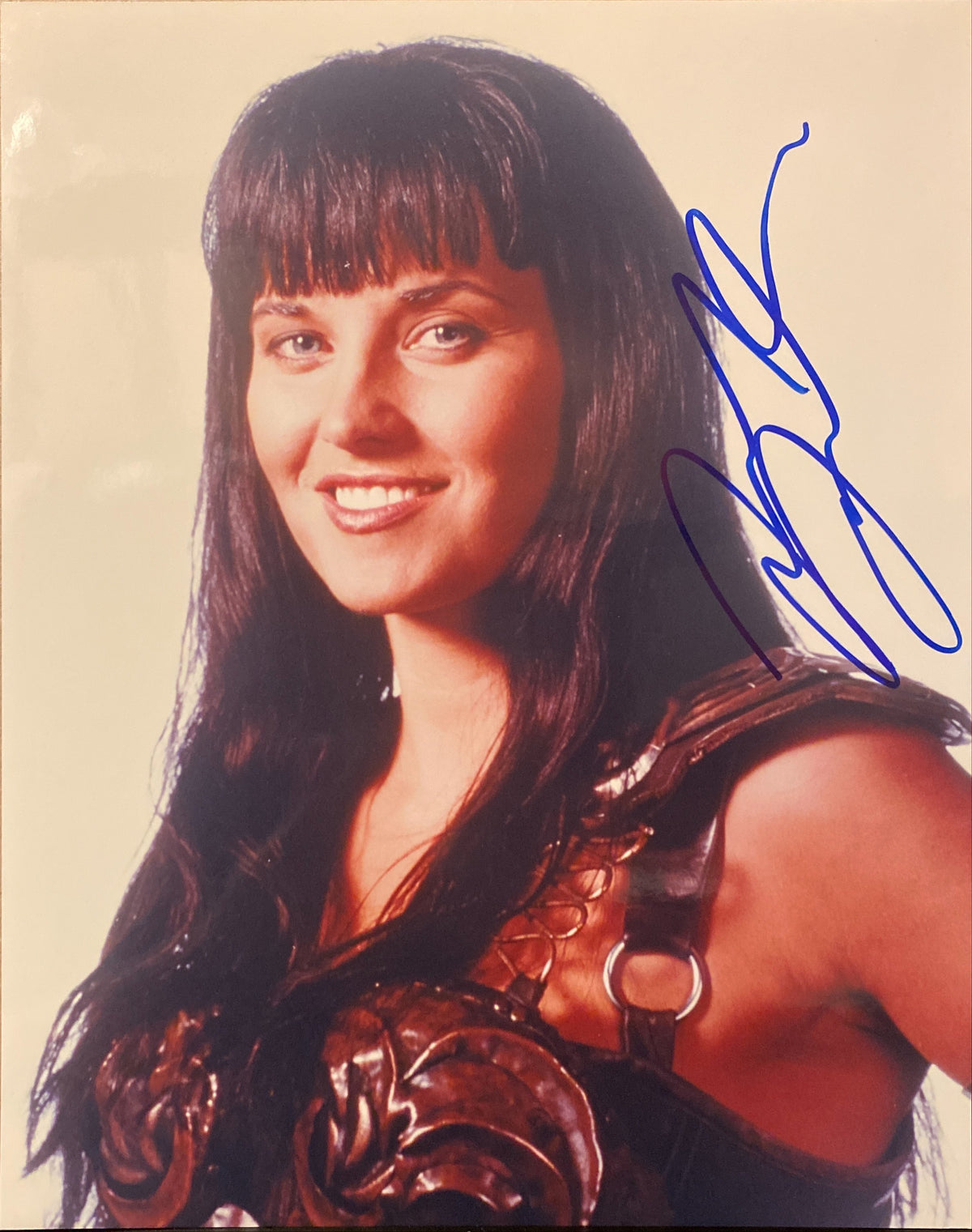 Lucy Lawless signed "Xena: Warrior Princess" photo